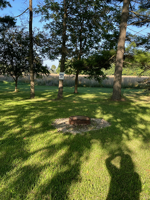 Image of campsite with fire pit at Der Happy Hallow