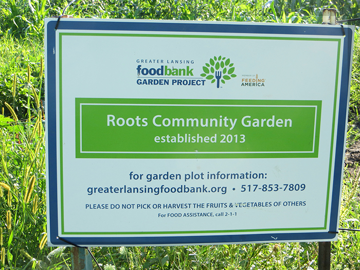 Sign about Roots Community Gardens at Der Happy Hallow